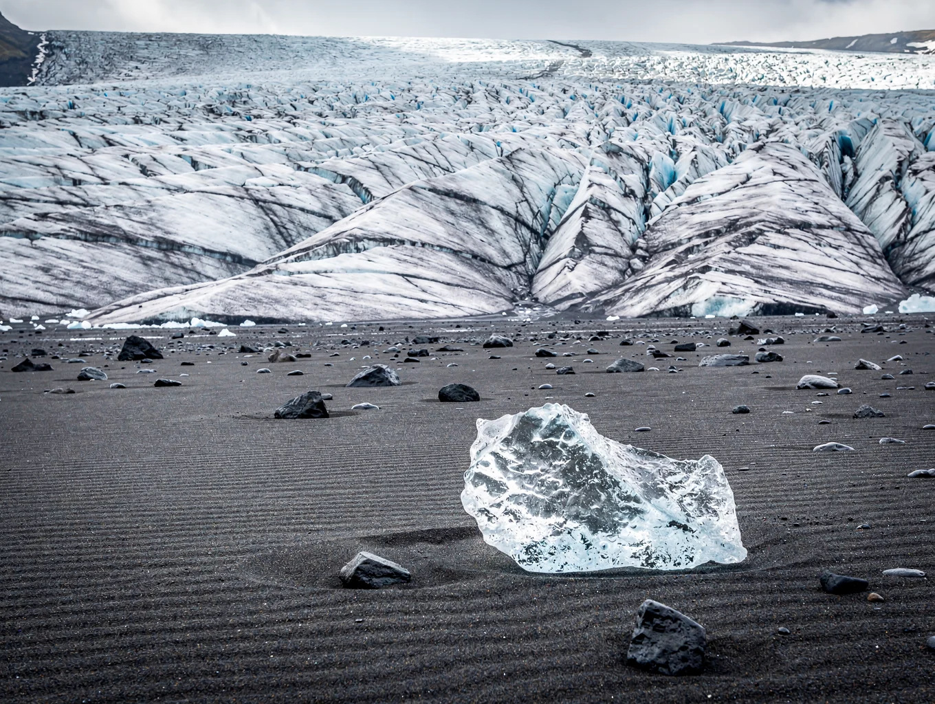 Black volcanic sand plains meeting glacial runoff in Iceland